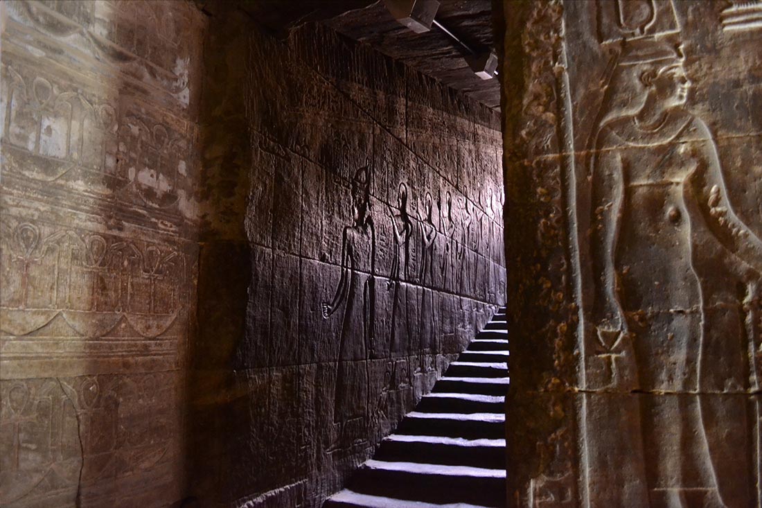 The Journey of Unveiling A staircase inside an ancient Egyptian temple, with light filtering through, representing the journey of enlightenment