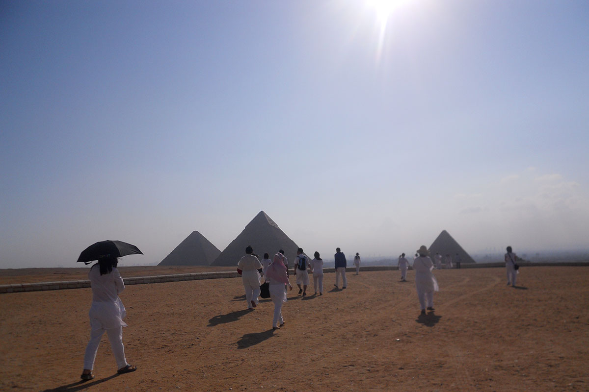 Giza Plateau, Egypt ATL Ministry initiates at the pyramids in Egypt at dusk after being initiated into the mysteries of Isis