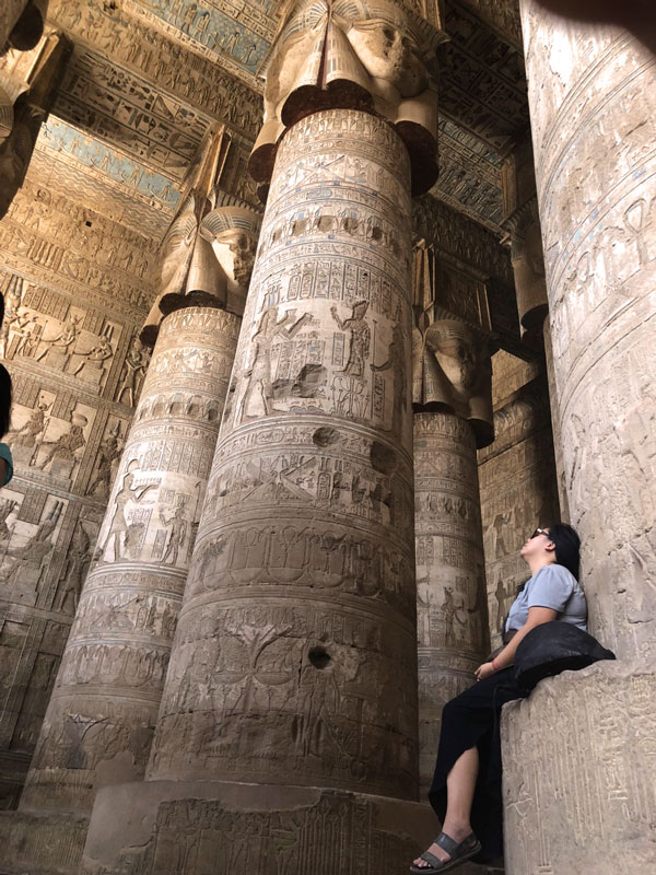 Reflections: Melting What Was Frozen A contemplative photo of a visitor sitting in meditation at the temple, Spiritual Tour Egypt