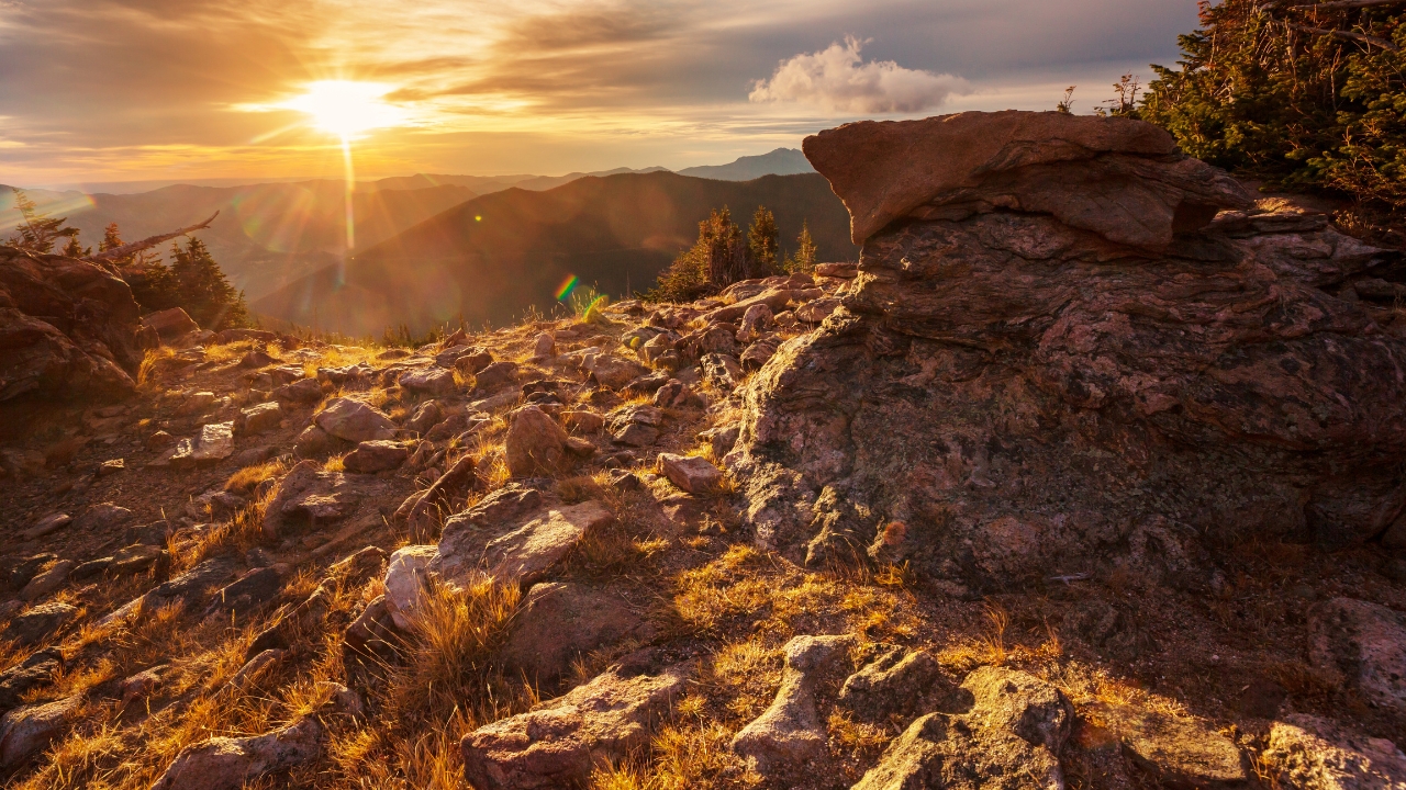 The Power of Transformation A sunrise over a rugged landscape, representing new beginnings and hope.