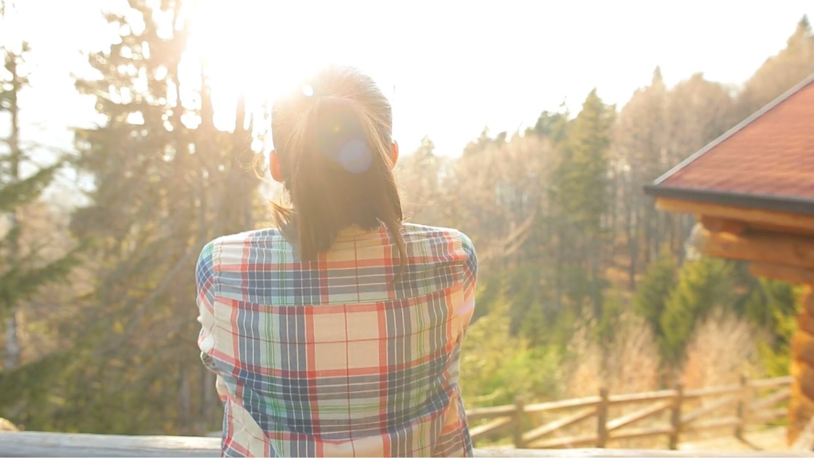Jordy’s New Journey Serene landscape with pine trees, lake, and cabins in golden hour light