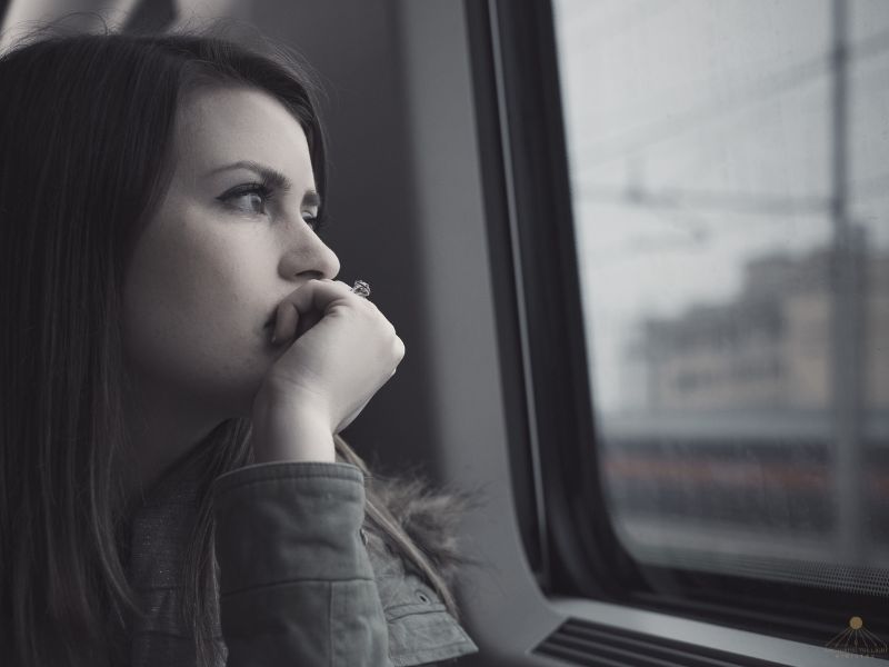 Breaking the Silence Around Mental Health Black and white photograph of a person looking out a window