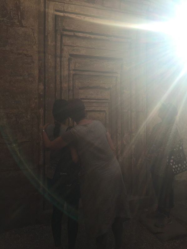 The Invitation to Transformation Sunrays on initiates in the portal in Karnak, Egypt