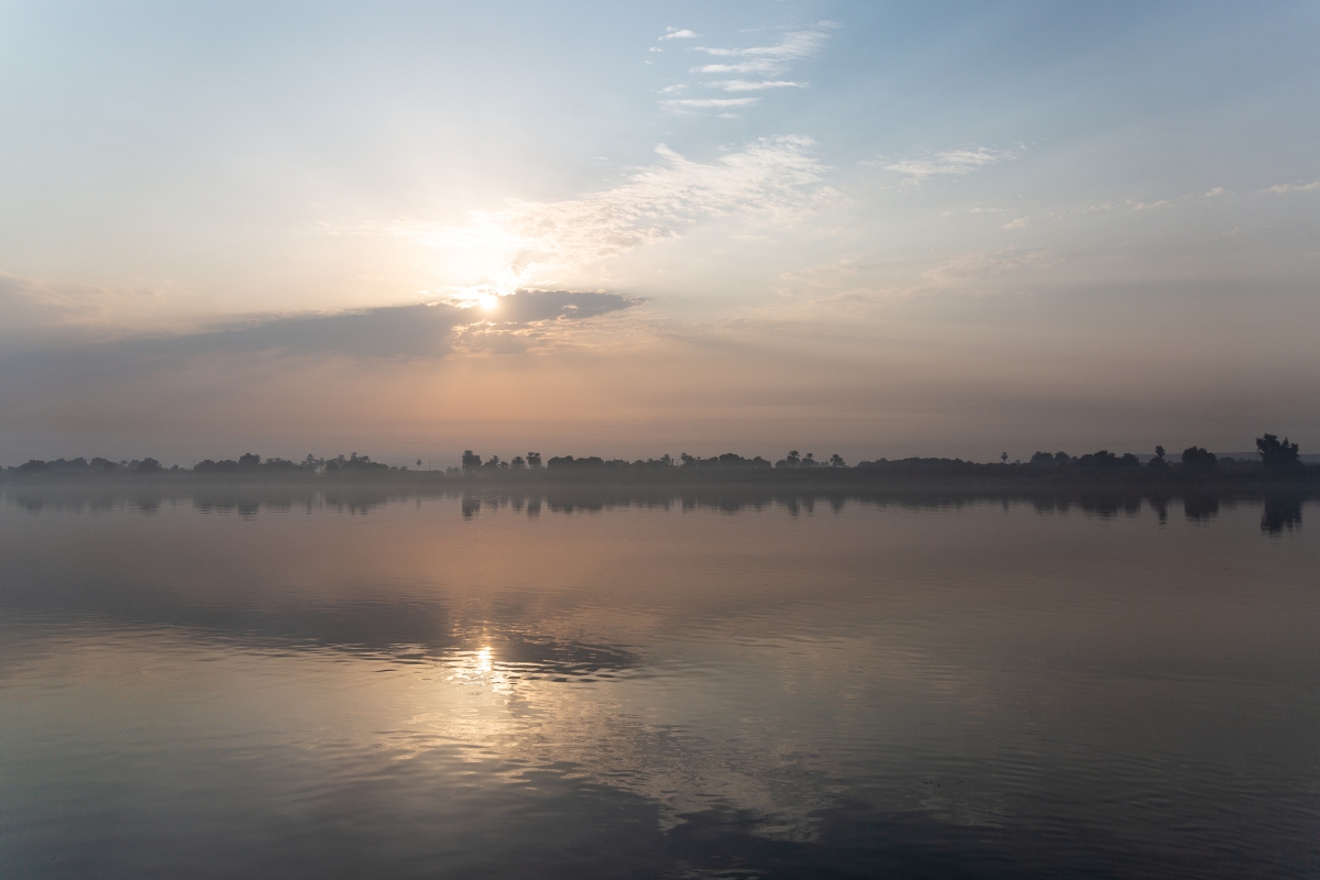 What Lies Beyond the Veil A Misty sunrise on the Nile River the temple of Isis in Egypt