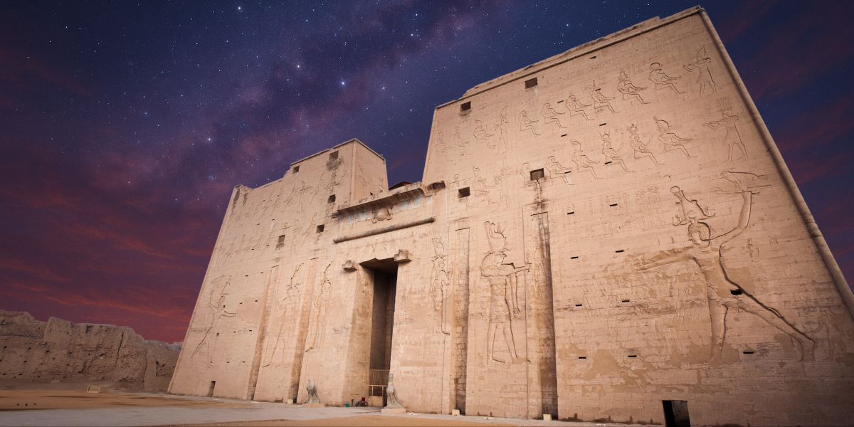 The Temple of Horus at Edfu glowing under twilight skies, evoking Zep Tepi mythology