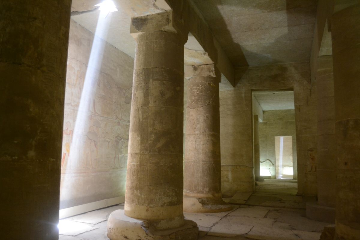 Dawn Light in the Temple of Abydos Sunlight filtering through temple columns in Egypt, evoking mystery and invitation.