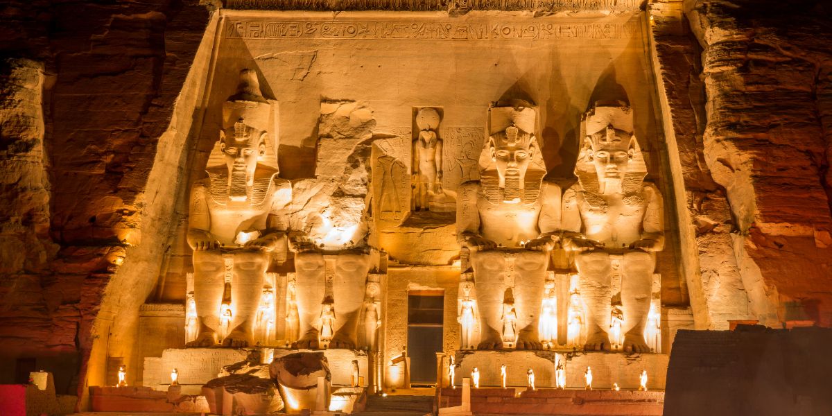 Inside the Abu Simbel inner temple of light with carved deities.