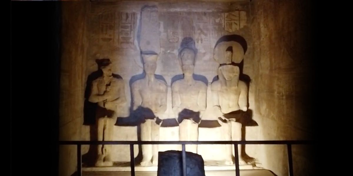 Inside the Abu Simbel inner temple of light with carved deities.