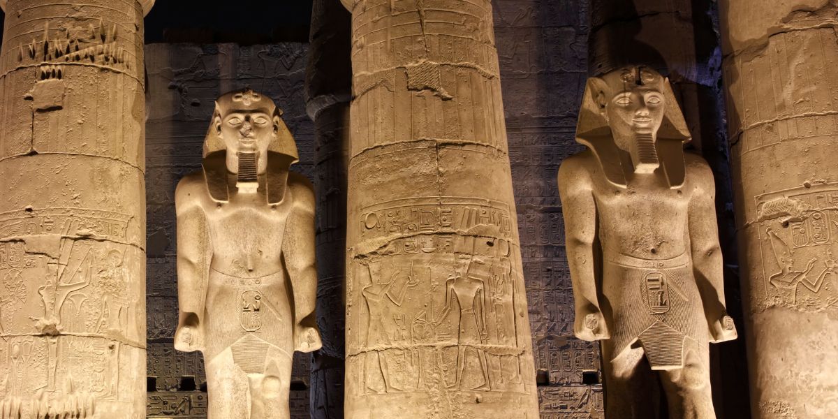 Ancient Light in Karnak Temple – Awaken on Your Spiritual Tour to Egypt Interior of an Luxor Temple, with light illuminating hieroglyphs & colossal statues, representing a soul journey on our spiritual tour to Egypt