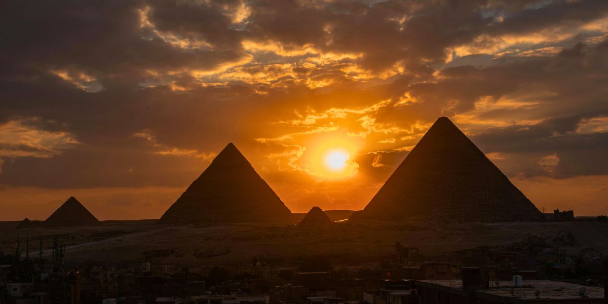 Spiritual awakening in Egypt – golden sunrise over the Pyramids of Giza reflecting divine remembrance