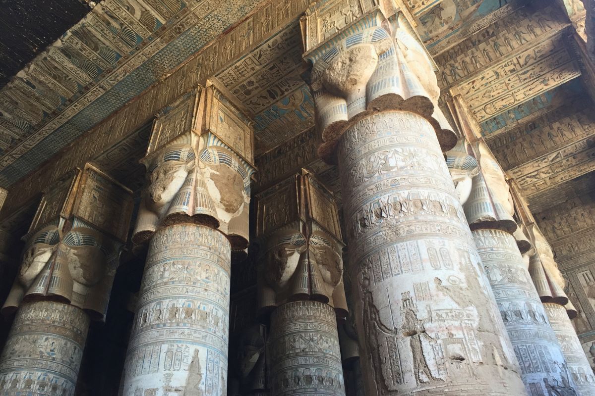Hathor-headed columns and painted ceiling inside the Temple of Hathor at Dendera, Egypt