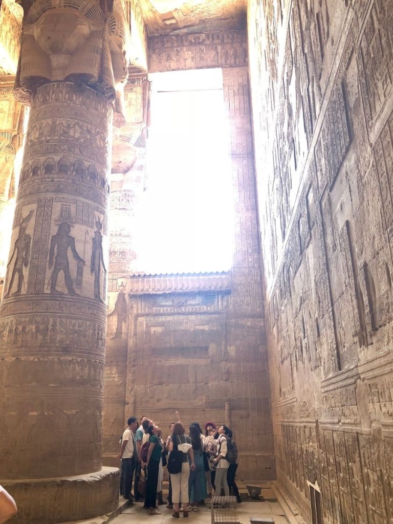 Alt: Group looking up at the celestial ceiling inside the Temple of Dendera in Egypt